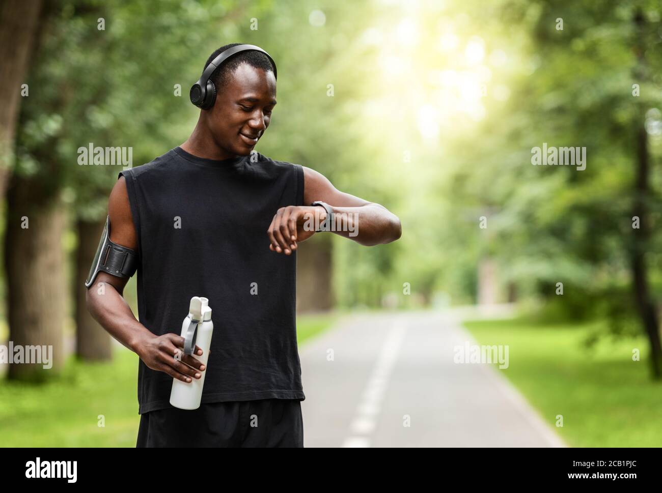 African sportsman working out with fitness bracelet Stock Photo