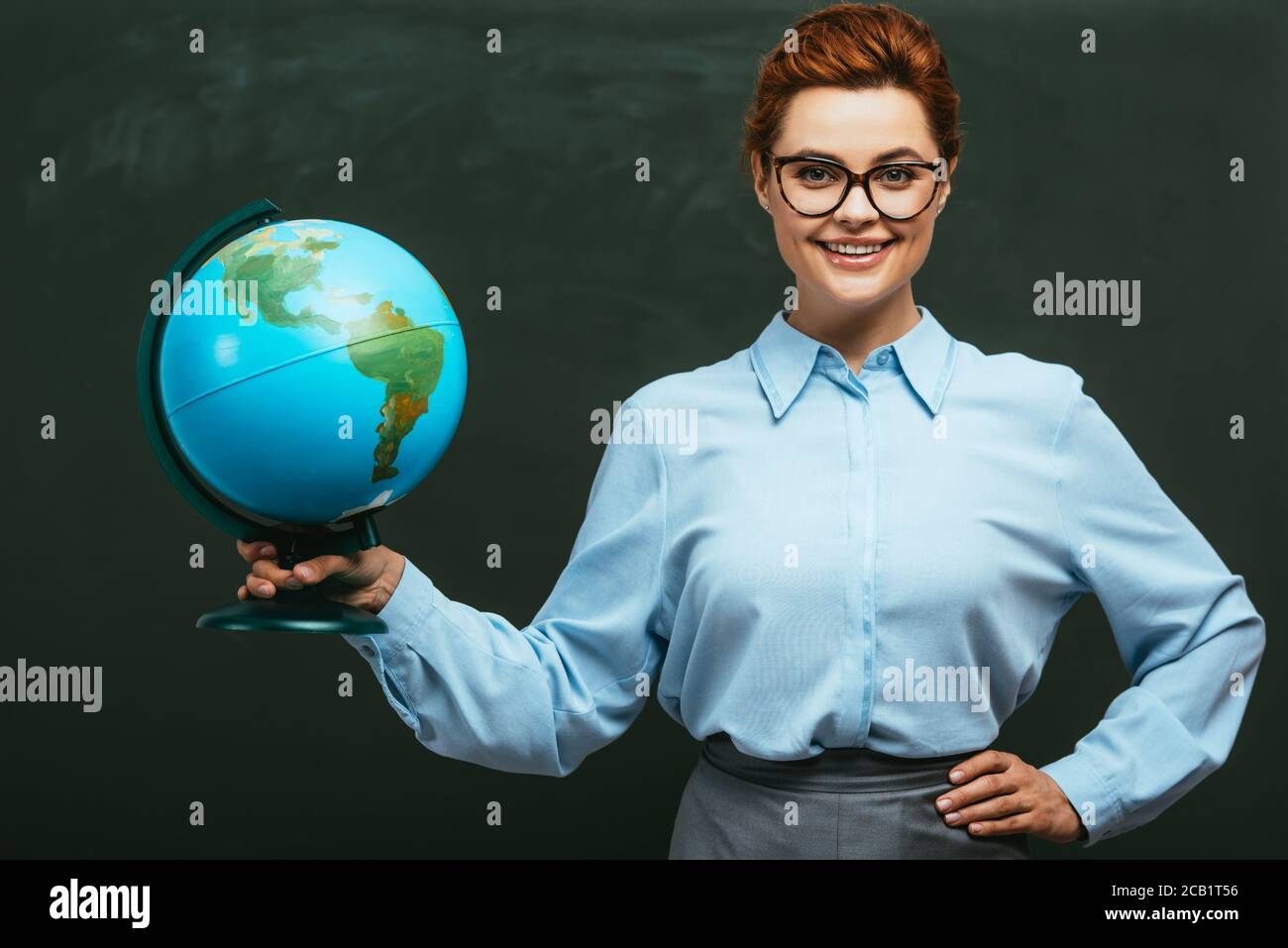 Woman holding globe on back hi-res stock photography and images - Alamy