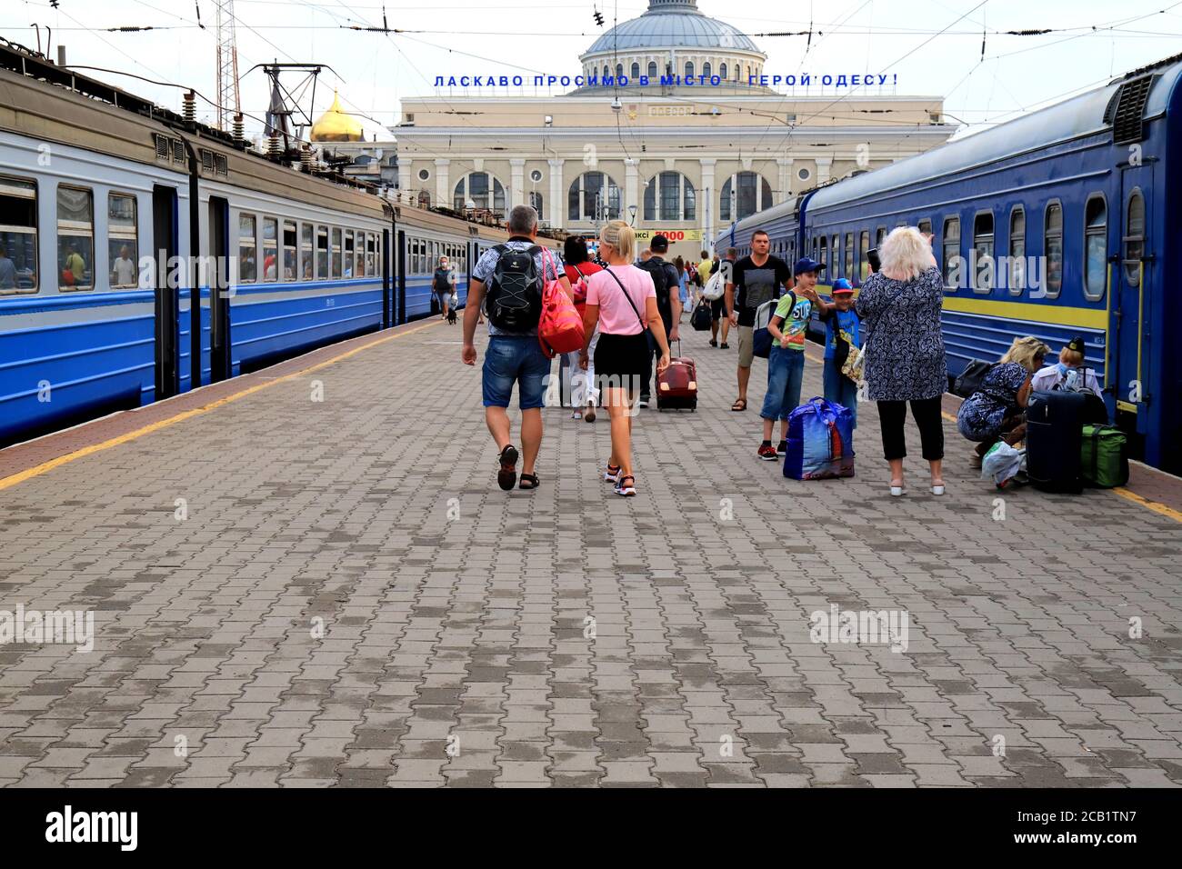 Odesa, Ukraine. 27 07 2020 A crowd of people walking along the platform with bags, suitcases and luggage at the Odessa railway station. Tourists Stock Photo