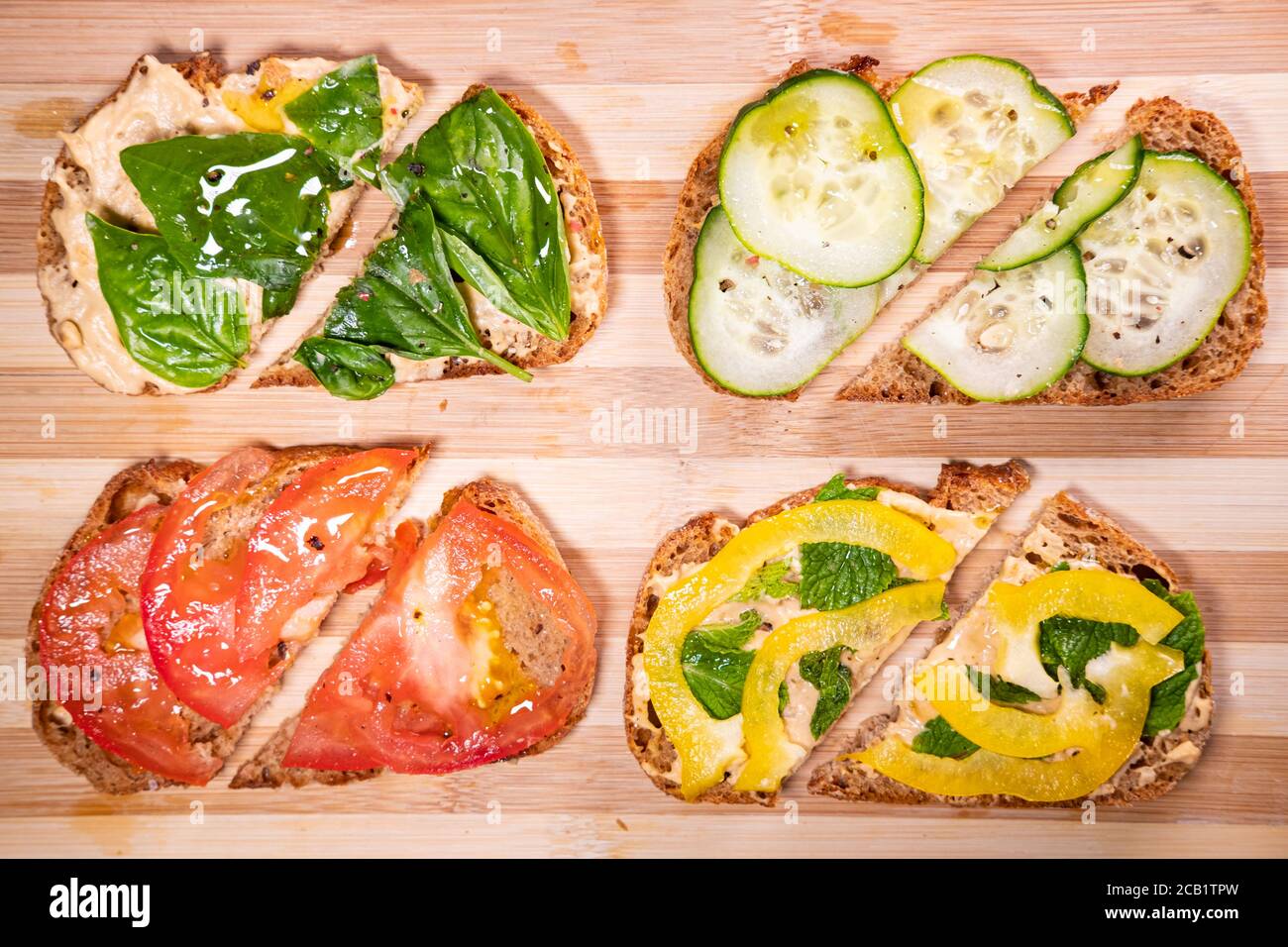 Plant based snadwiches on a cutting board, top view. Vegan lunch, vegetarian snacks, healthy food option Stock Photo