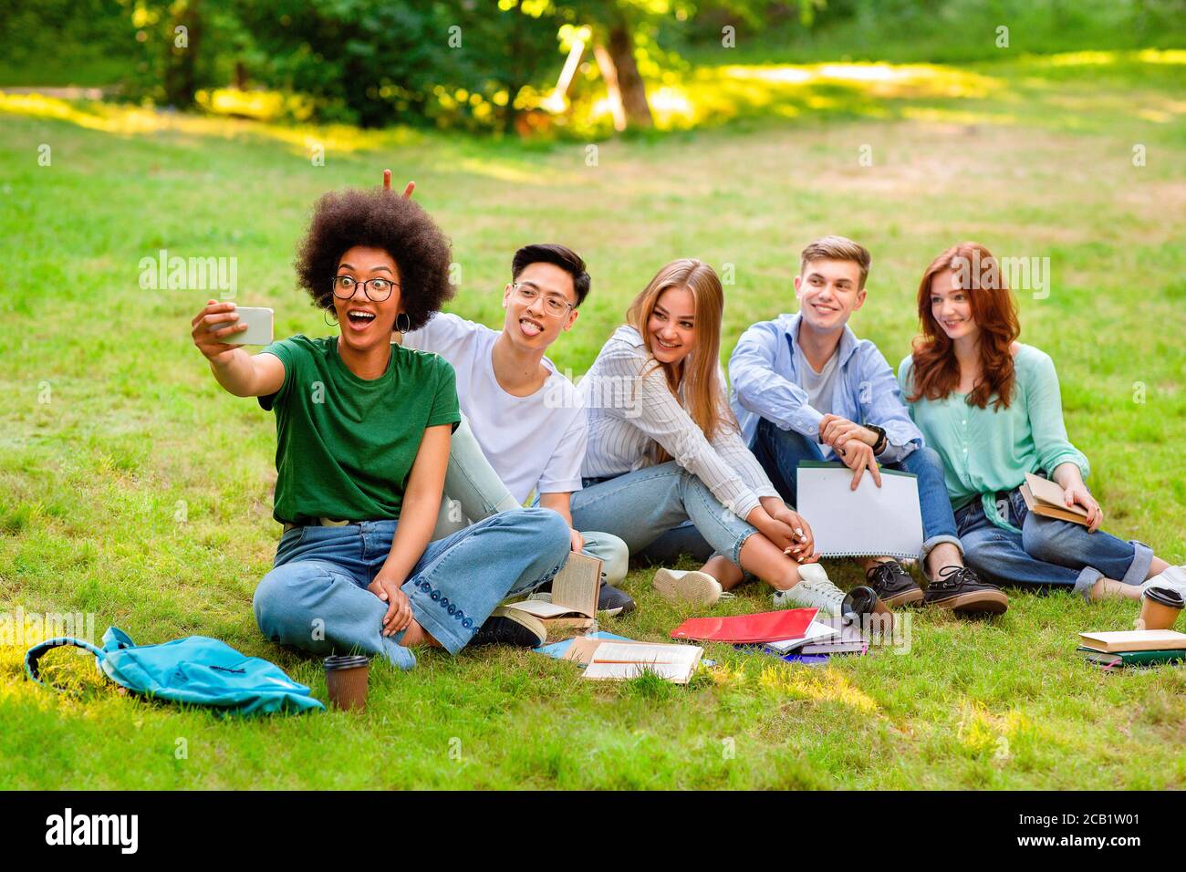 Happy Multicultural College Students Having Fun While Taking Group Selfie Outdoors Stock Photo