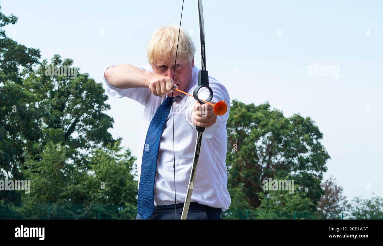 Prime Minister Boris Johnson takes part in archery during a visit to