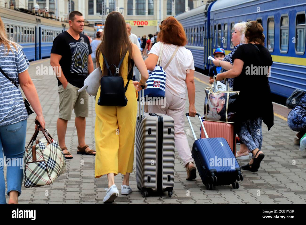 Odesa, Ukraine. 27 07 2020 A crowd of people walking along the platform with bags, suitcases and luggage at the Odessa railway station. Tourists Stock Photo