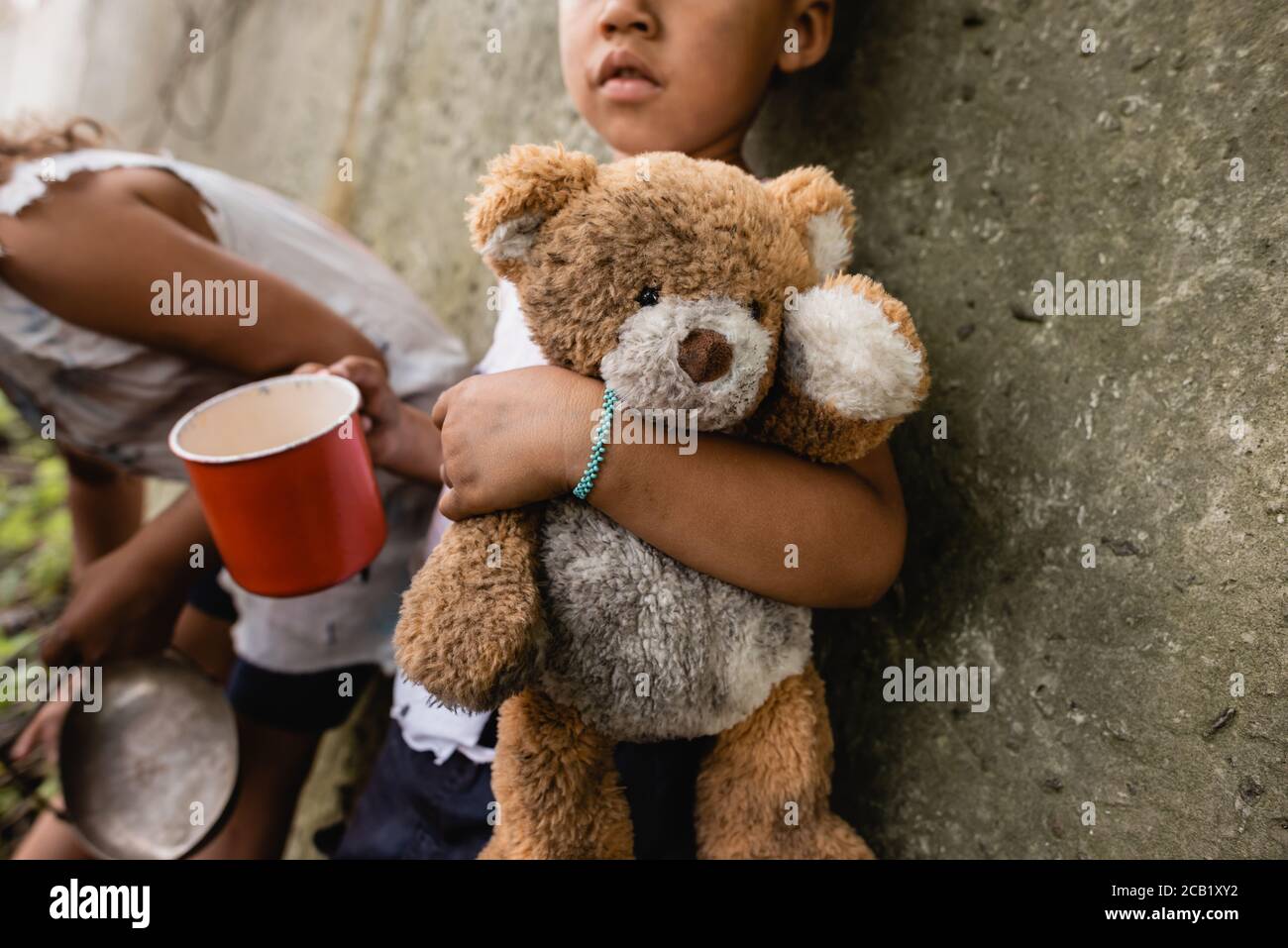 Cropped View Of Homeless African American Children With Dirty Teddy Bear Begging Alms In Slum Stock Photo Alamy