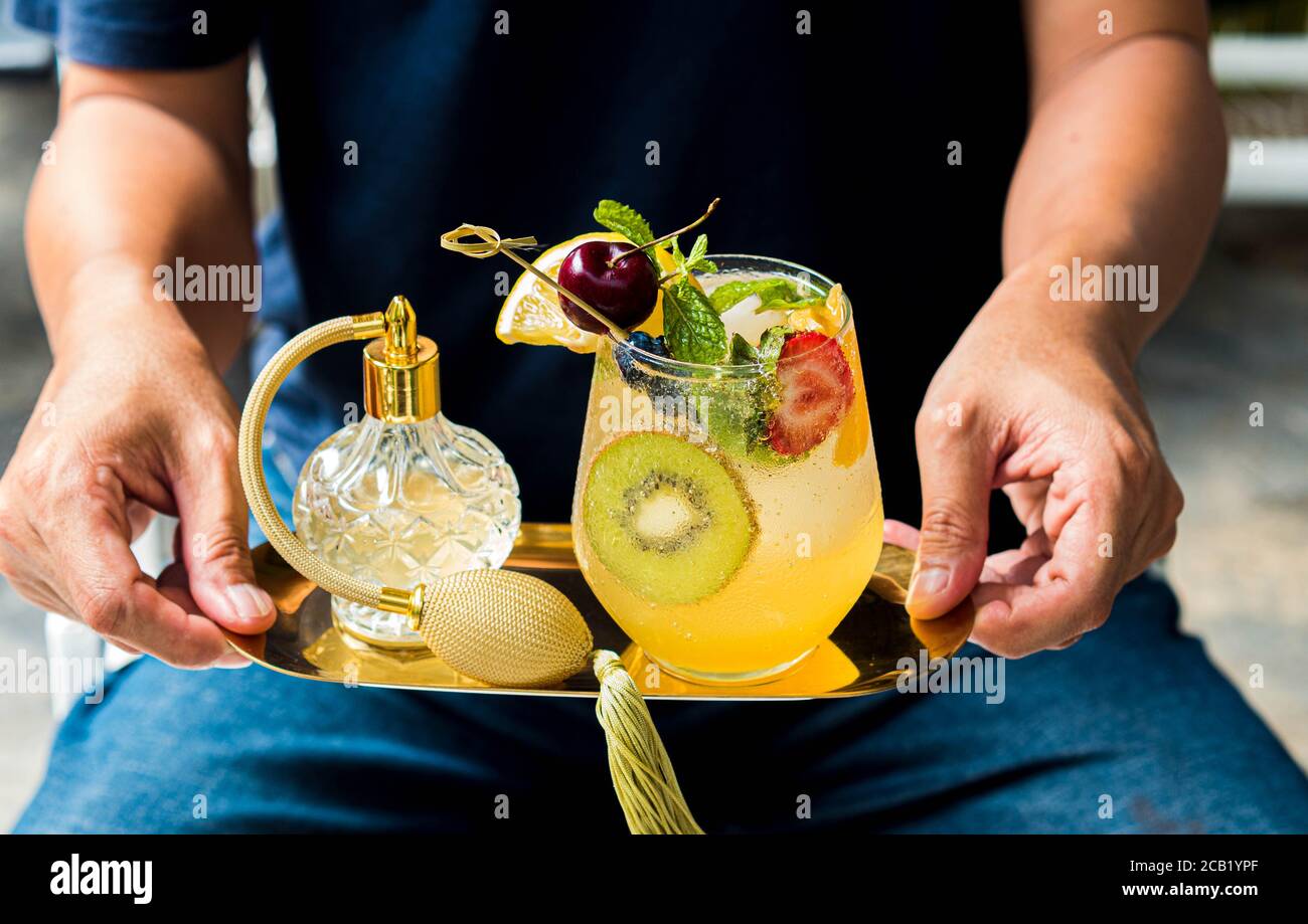 mocktail glass high resolution stock photography and images alamy https www alamy com asian man hold glass of mocktail or cocktail serving mocktail glass mixed fruit non alchohol cocktail image368222695 html