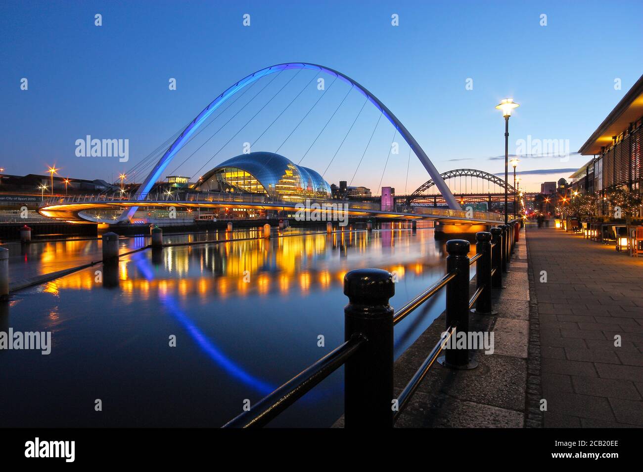 The Millennium and Tyne Bridges spanning the River Tyne between Newcastle and Gateshead in Tyne and Wear, North-East England. Taken at dusk during the Stock Photo