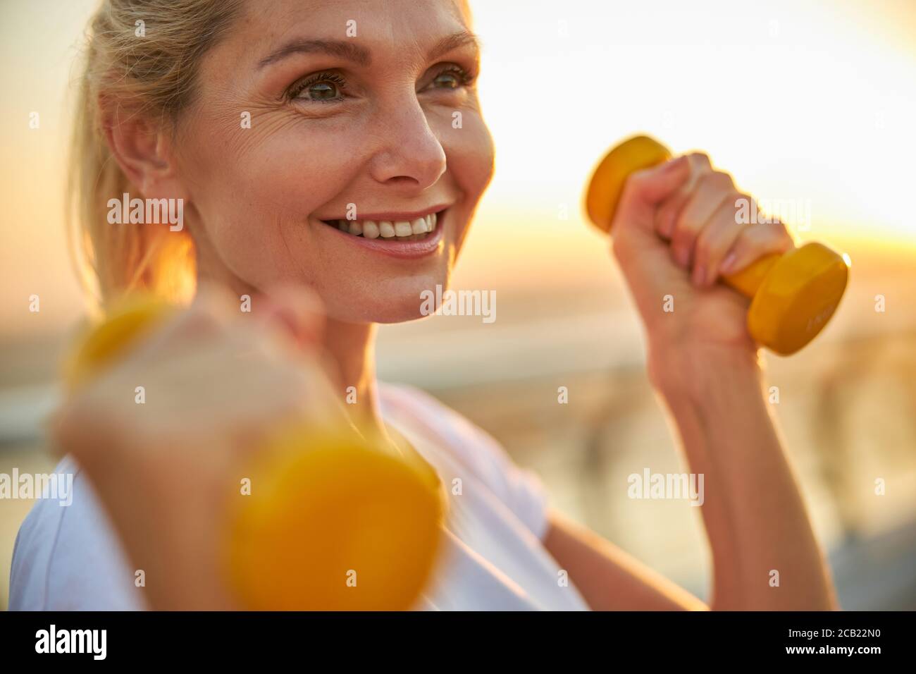 Beautiful high-spirited sportswoman looking into the distance Stock Photo