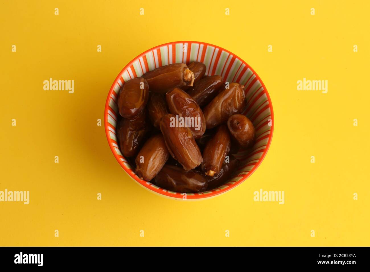 Top view closeup of a bowl of fruits similar to raisins called dates