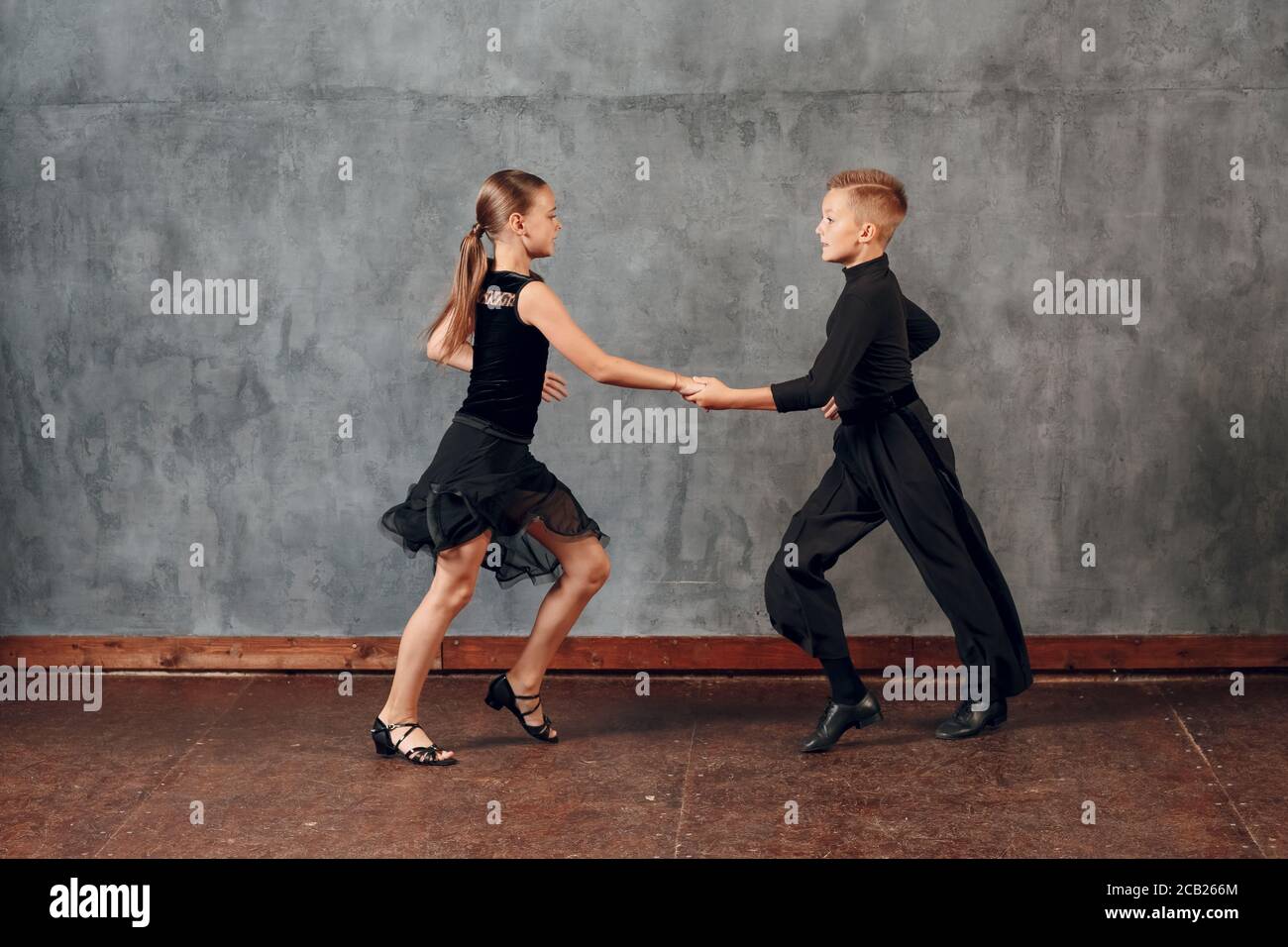 Young couple boy and girl dancing in ballroom dance Jive Stock Photo