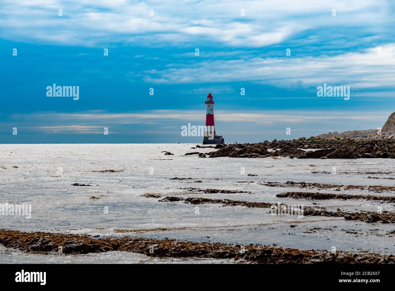 Eastbourne lighthouse at low tide Stock Photo