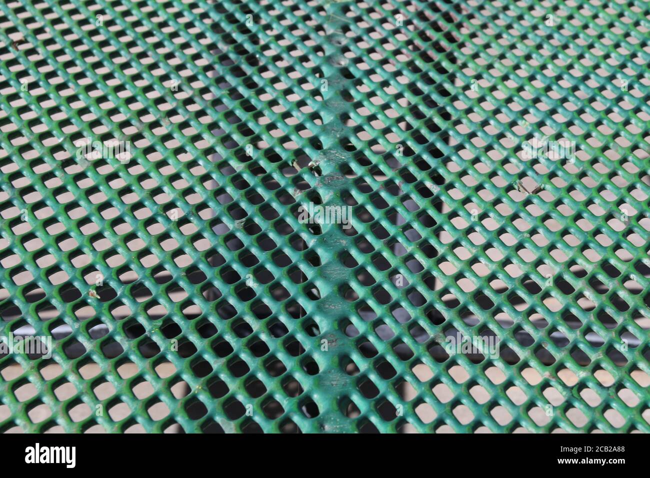 green close-up angle outdoors metal perforated picnic table suitable for website marketing background backdrop setting architecture architectural layo Stock Photo