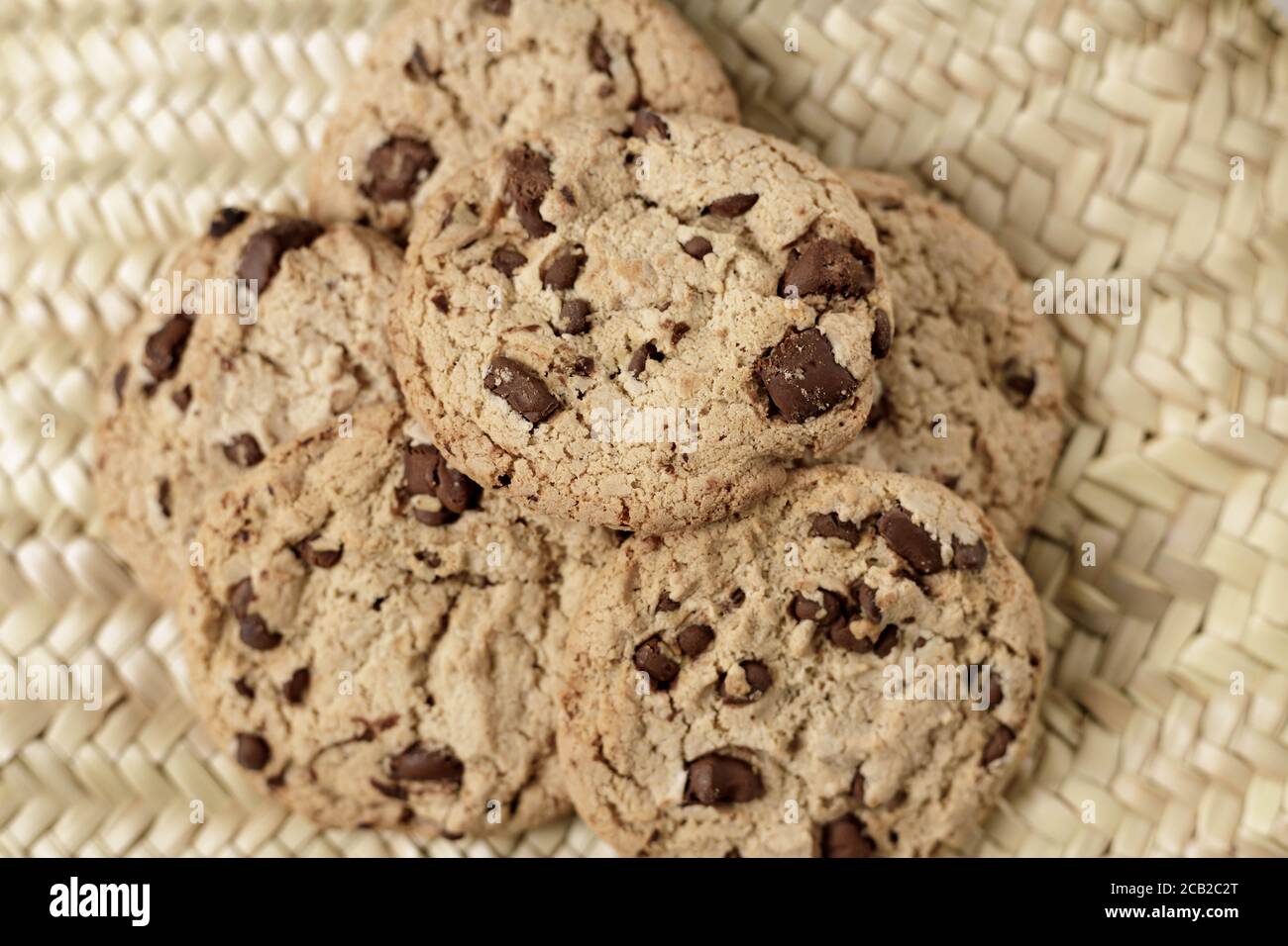 Home made chocolate cookies pile on a natural wicker surface Stock Photo