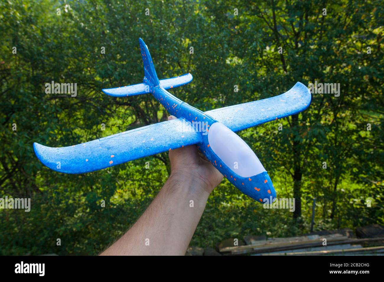toy foam airplane in hands Stock Photo