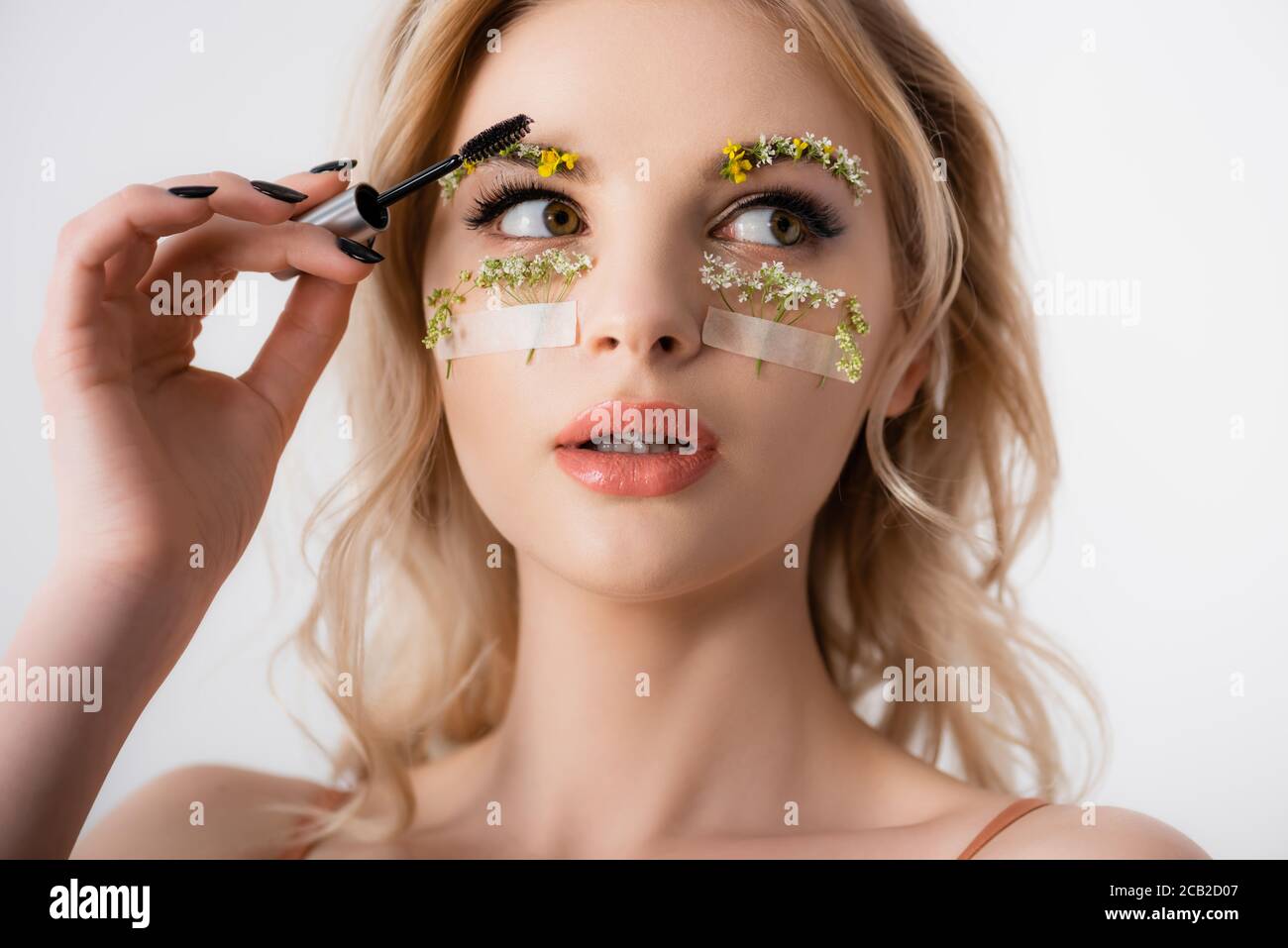 Beautiful Blonde Woman Styling Wildflowers On Eyebrows With Brow Gel