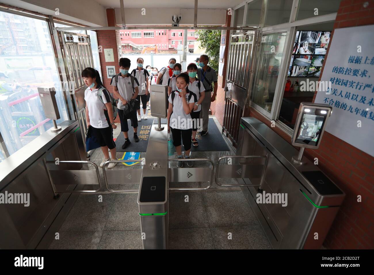 Wuhan, China's Hubei Province. 10th Aug, 2020. Students have their temperature checked before entering the Hubei Shuiguohu No. 1 Middle School in Wuhan, central China's Hubei Province, Aug. 10, 2020. Junior high schools in Wuhan reopened and resumed classes for students in their first and second grades on Monday. Credit: Zhao Jun/Xinhua/Alamy Live News Stock Photo