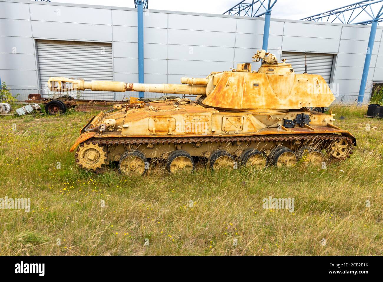 Corroding 2S3 Akatsiya self-propelled gun tank at Imperial War Museum, Duxford, UK. Armoured fighting vehicle, AFV. Out to grass. Gulf War material Stock Photo