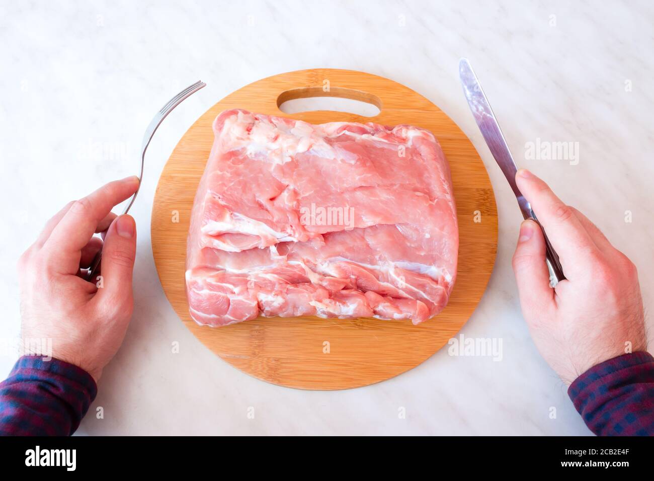 man eating raw meat Stock Photo - Alamy