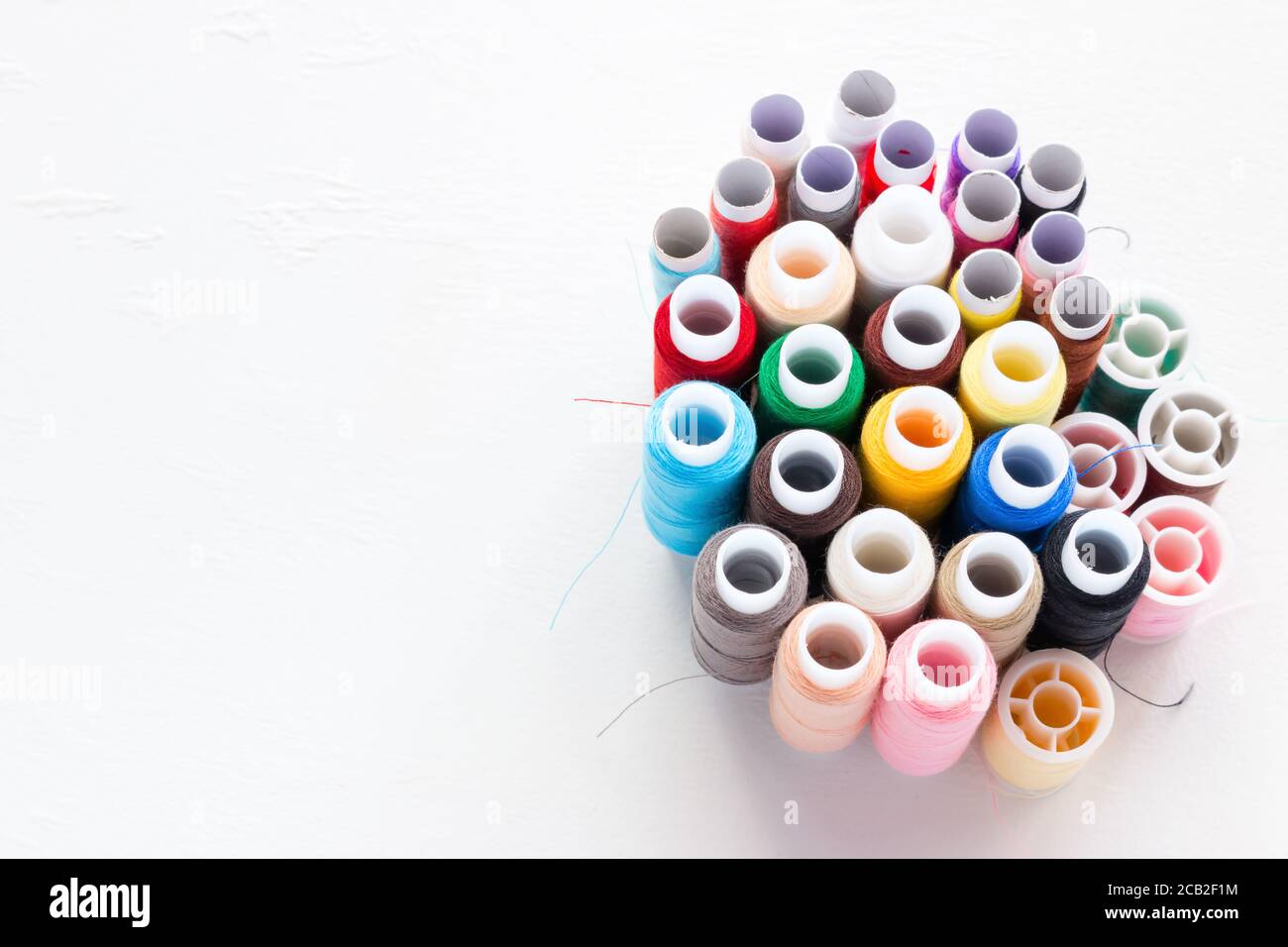 multicolored thread on white background with place for text Stock Photo