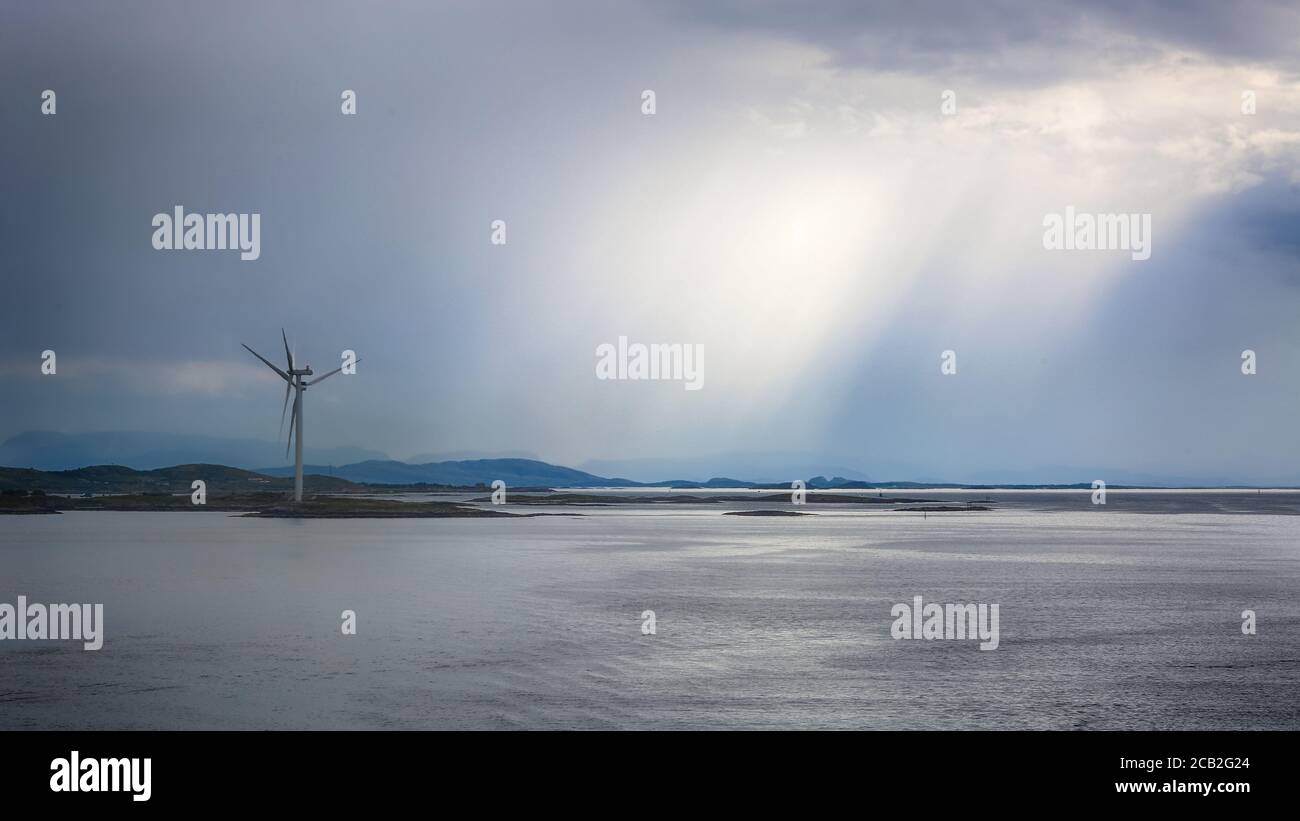 Windgenerators standing along Norwegian coast line in the Bjugn district, Norway, just before storm in the summer Stock Photo