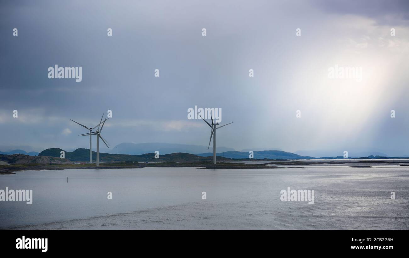 Windgenerators standing along Norwegian coast line in the Bjugn district, Norway, just before storm Stock Photo