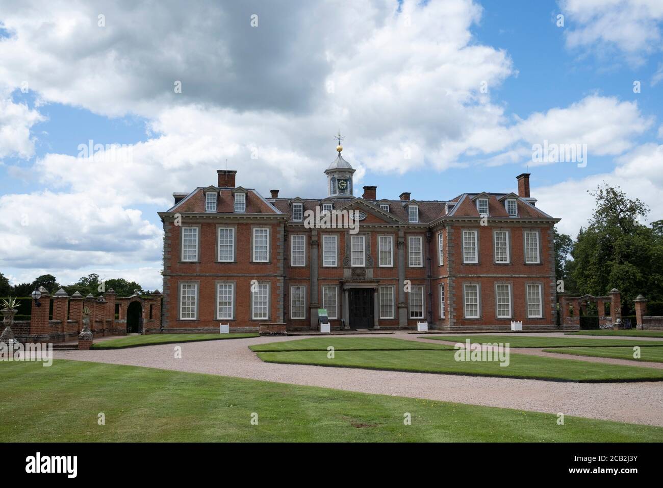 Hanbury Hall on 10th July 2020 in Hanbury, United Kingdom. Hanbury Hall is a large 18th-century stately home standing in parkland at Hanbury, Worcestershire. The main range has two storeys and is built of red brick in the Queen Anne style. It is a Grade I listed building, and the associated Orangery and Long Gallery pavilion ranges are listed Grade II. It is managed by the National Trust and is open to the public. Stock Photo