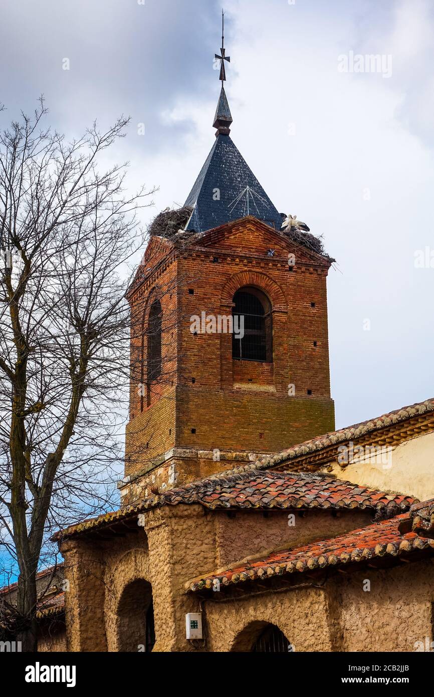 Tower of the church of El Burgo Ranero, with large stork nests. Impression from the Camino de Santiago de Compostela in Spain. Stock Photo