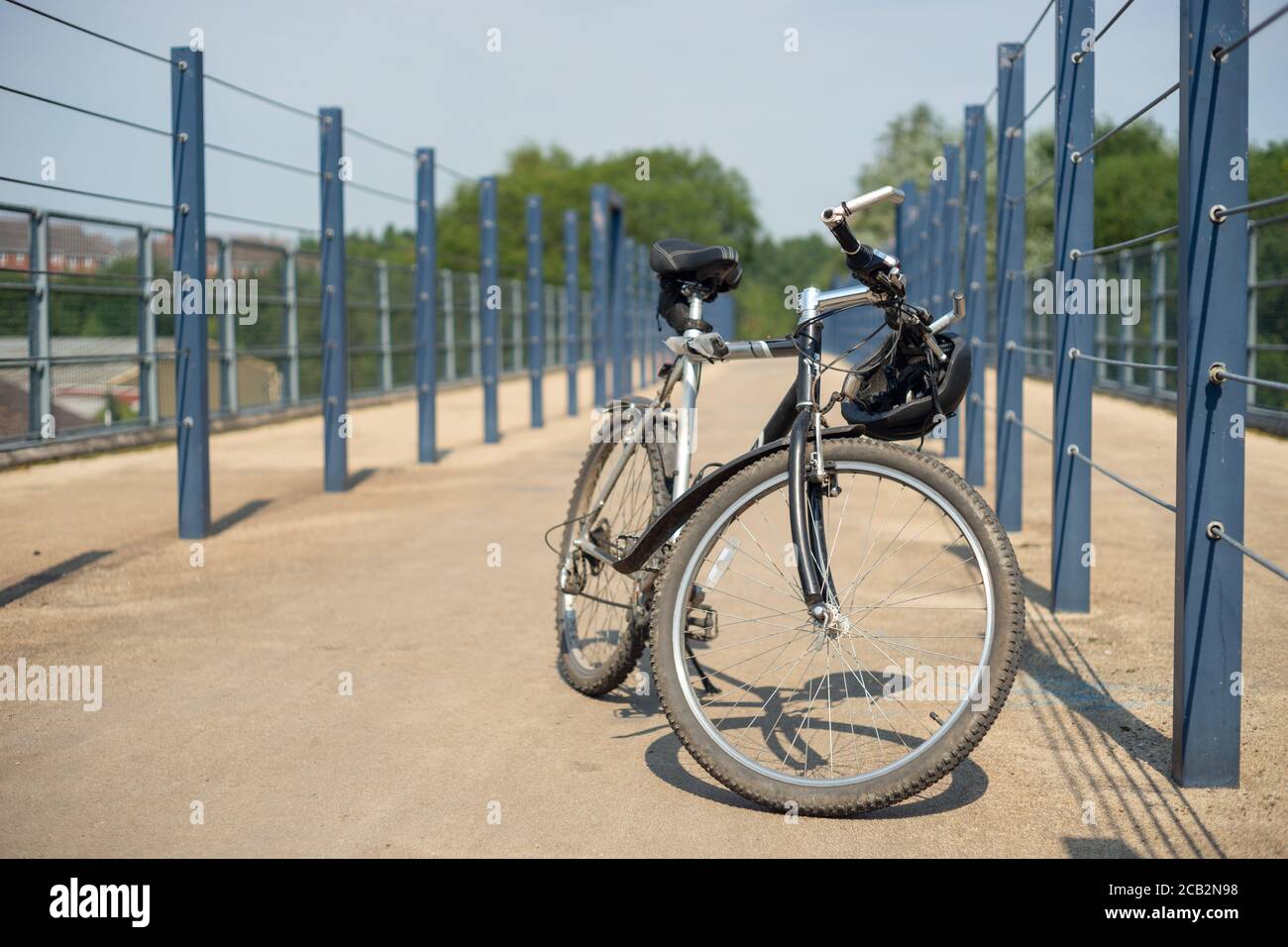 Silver bike or bicycle on cycle path over a bridge in Radcliffe, Manchester UK.  keep fit, outdoors, cycling, activity, health, wellbeing, exercise Stock Photo