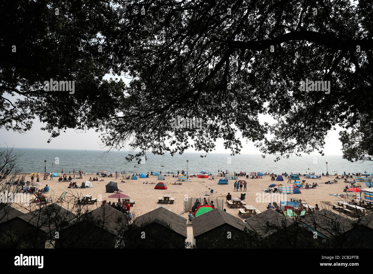 People enjoy the warm weather on Avon beach in Mudeford, Dorset Stock