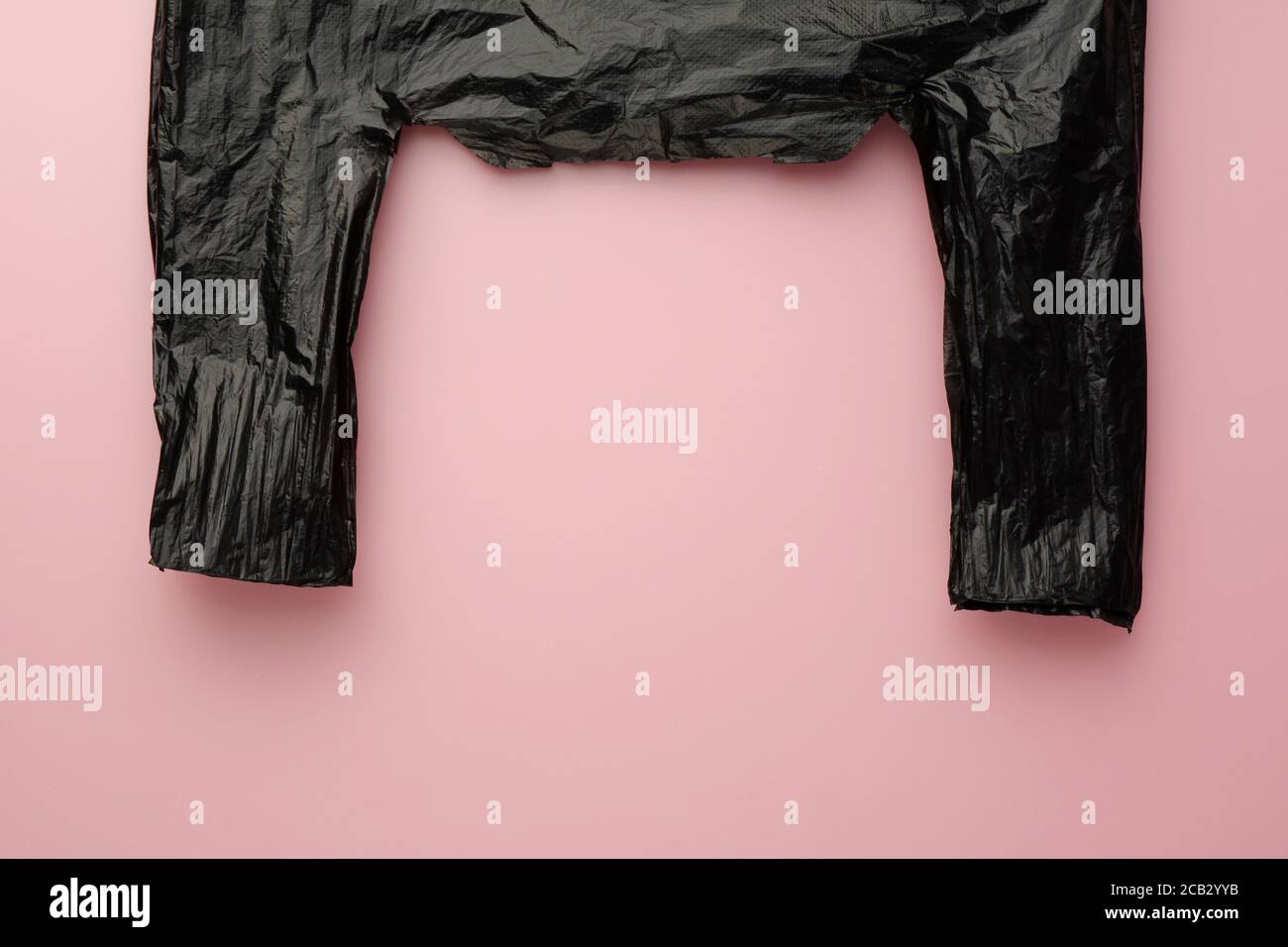 Clear disposable black plastic bag on pink background Stock Photo Alamy