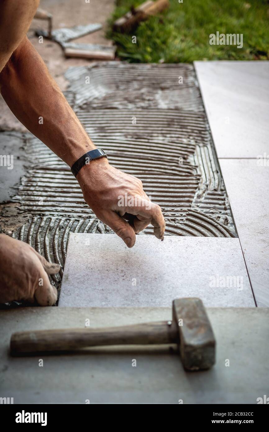 Tile installation with glue on concrete floor Stock Photo Alamy