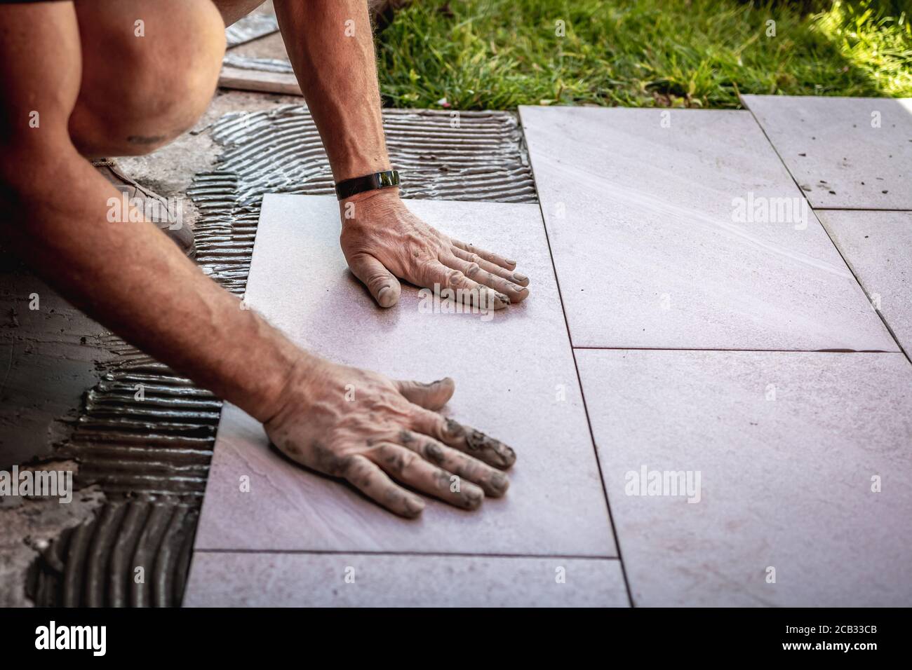 Tile installation with glue on concrete floor Stock Photo Alamy