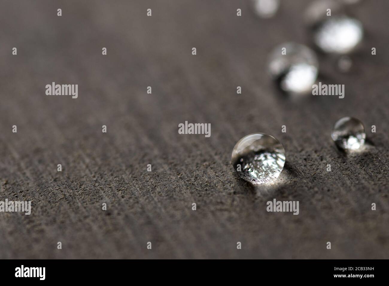 Water droplets on flat grey surface Stock Photo