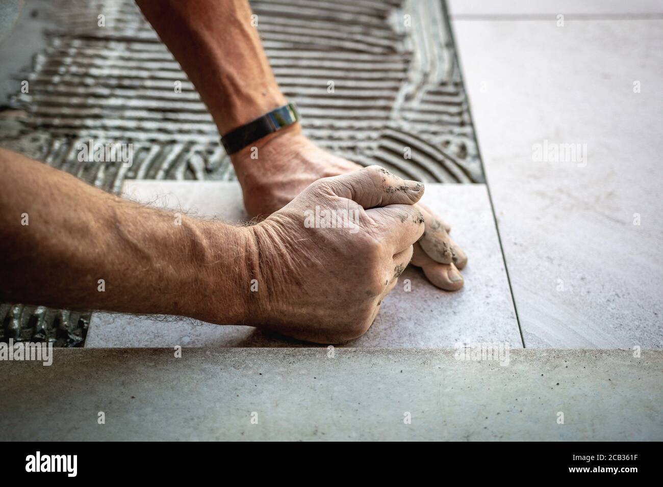 Tile installation with glue on concrete floor Stock Photo Alamy