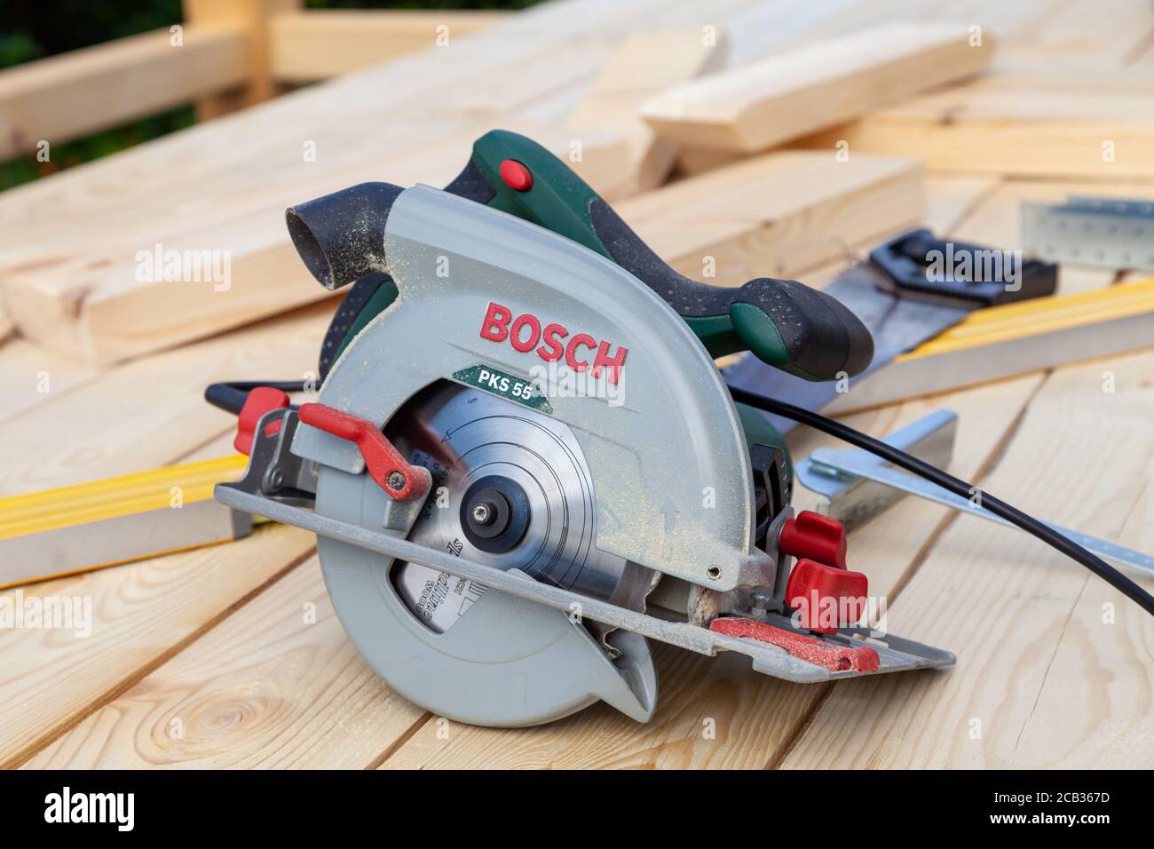 Novosibirsk, Russia - 07.04.20: Close-up of a modern new electric hand saw Bosch PKS 55 with a green plastic case and a metal blade on a wooden d Stock Photo - Alamy