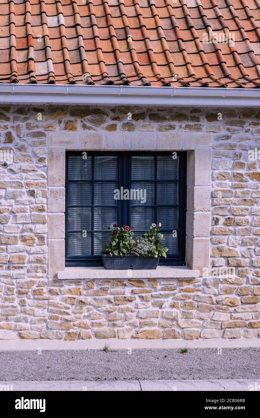 Window has small tiles. Stone house and roof tile Stock Photo - Alamy
