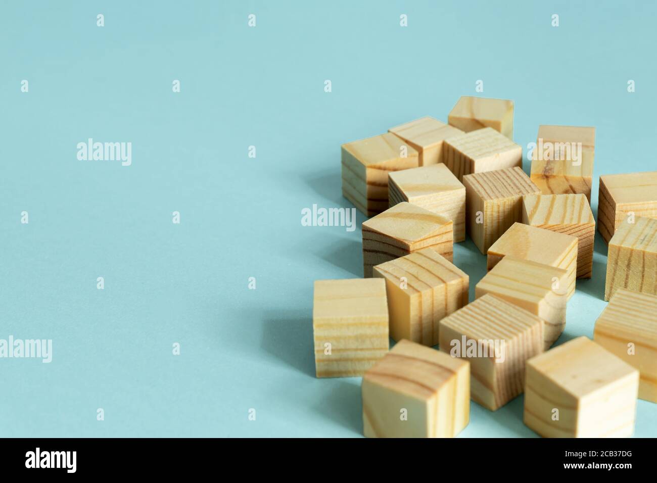 Construction of wooden cubes on blue background with copy space. Mockup ...