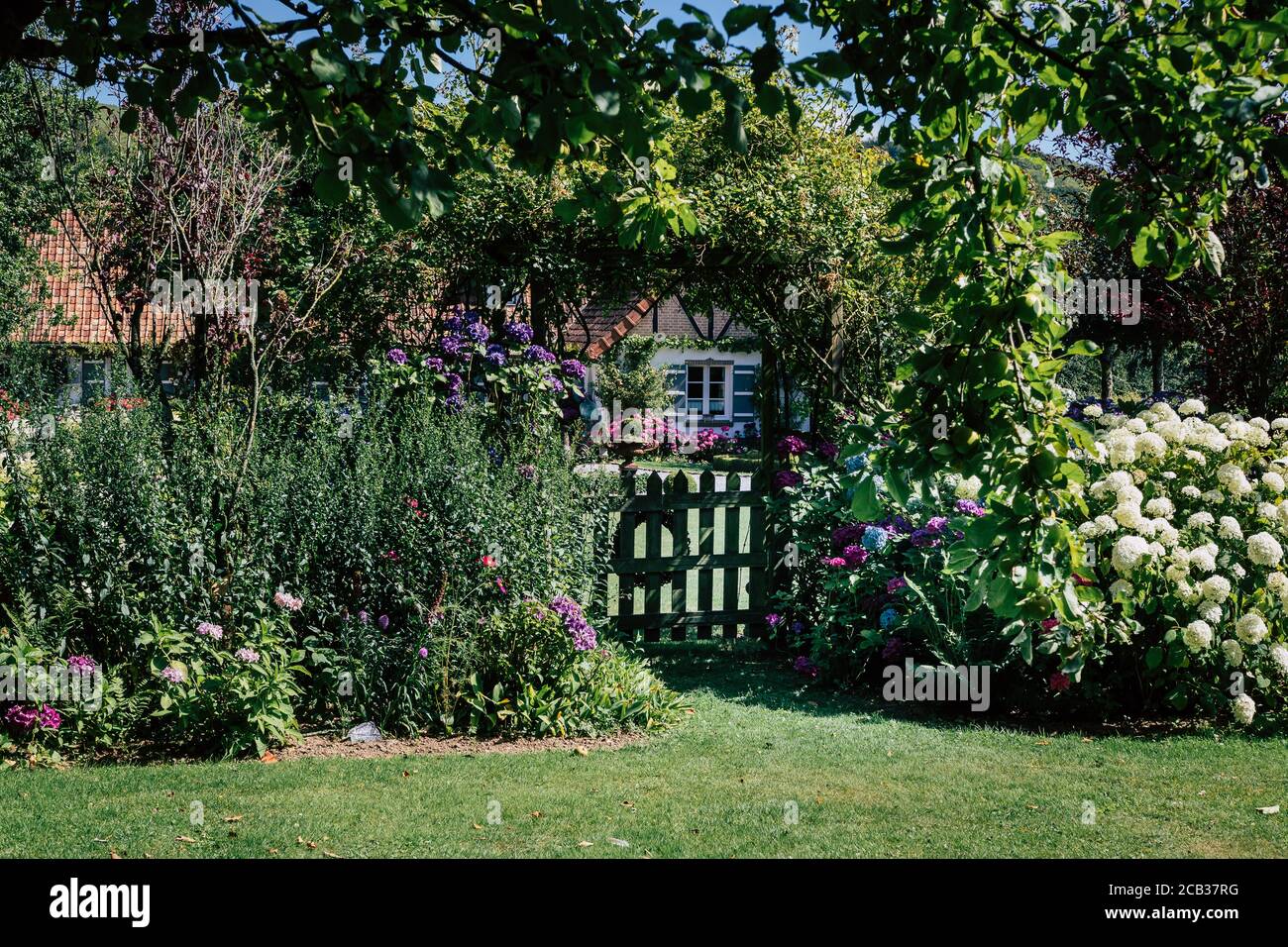 Beautiful Flower Garden With Small Wooden Gate And House In The beautiful-flower-garden-with-small-wooden-gate-and-house-in-the