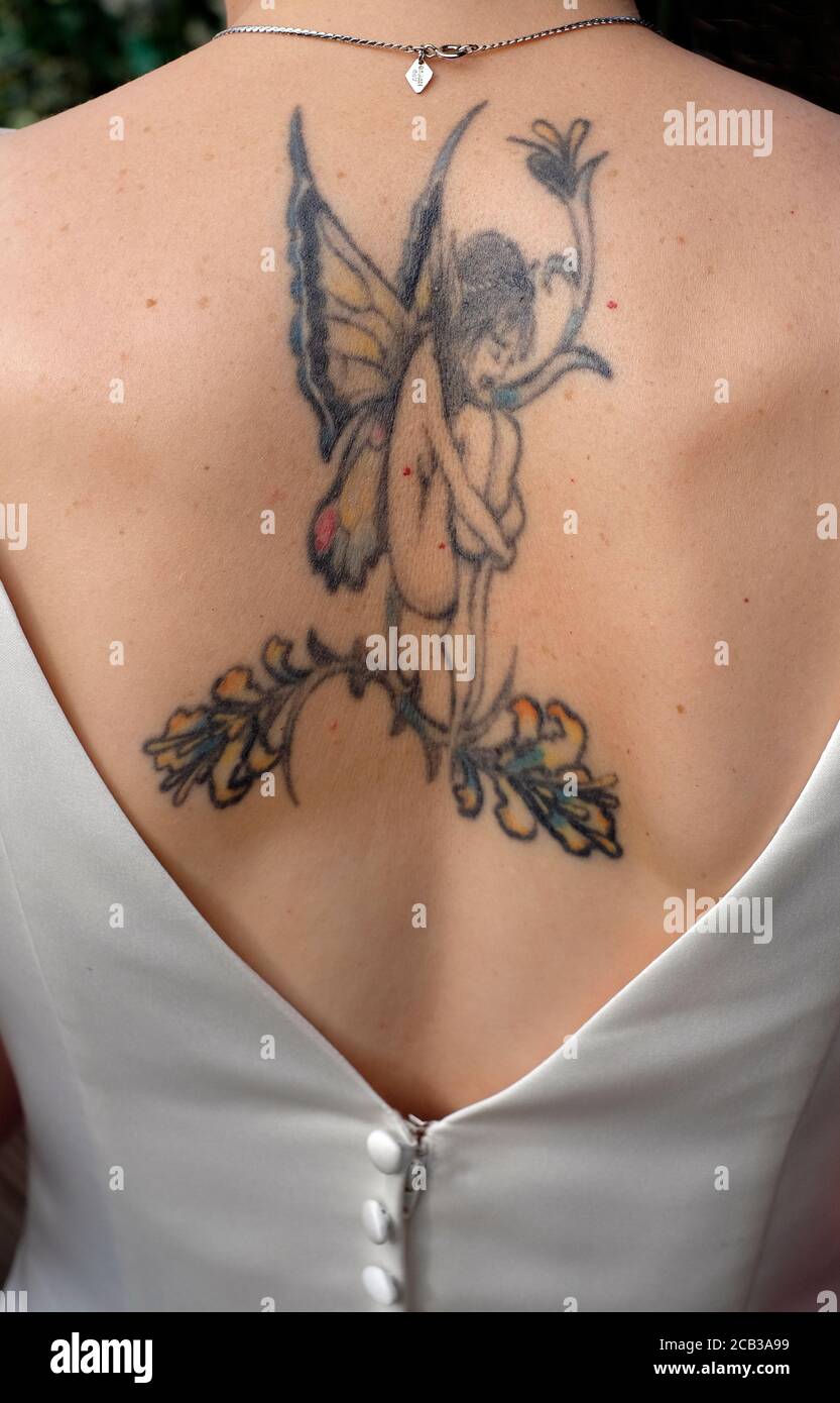 tattoo of fairy on female back, norfolk, england Stock Photo