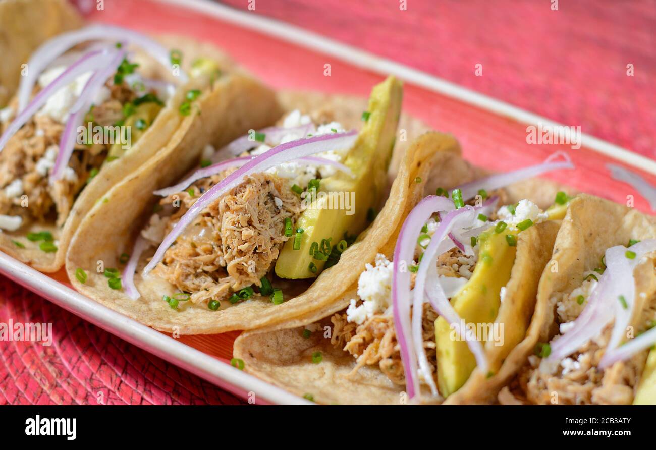 Tacos with chicken, avocado and onion and feta cheese Stock Photo