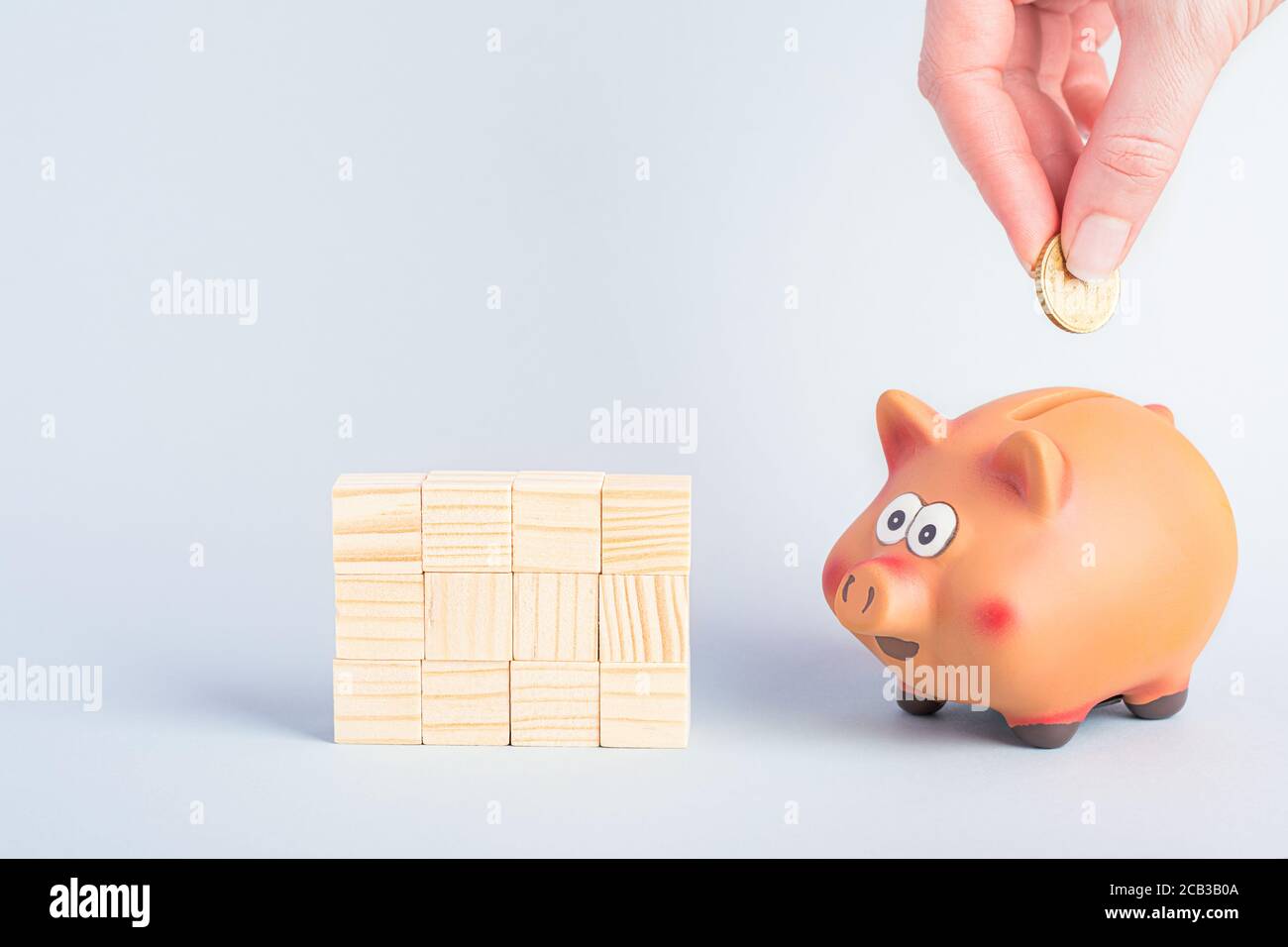 Putting a coin into a piggy bank hi-res stock photography and images ...