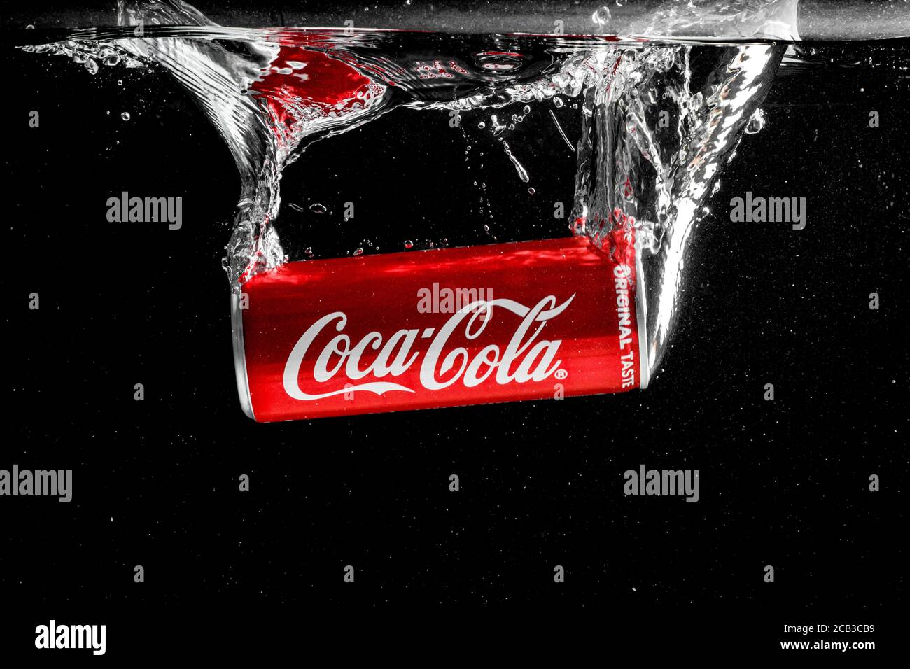 Coca cola can splashing in to water on black background Stock Photo - Alamy