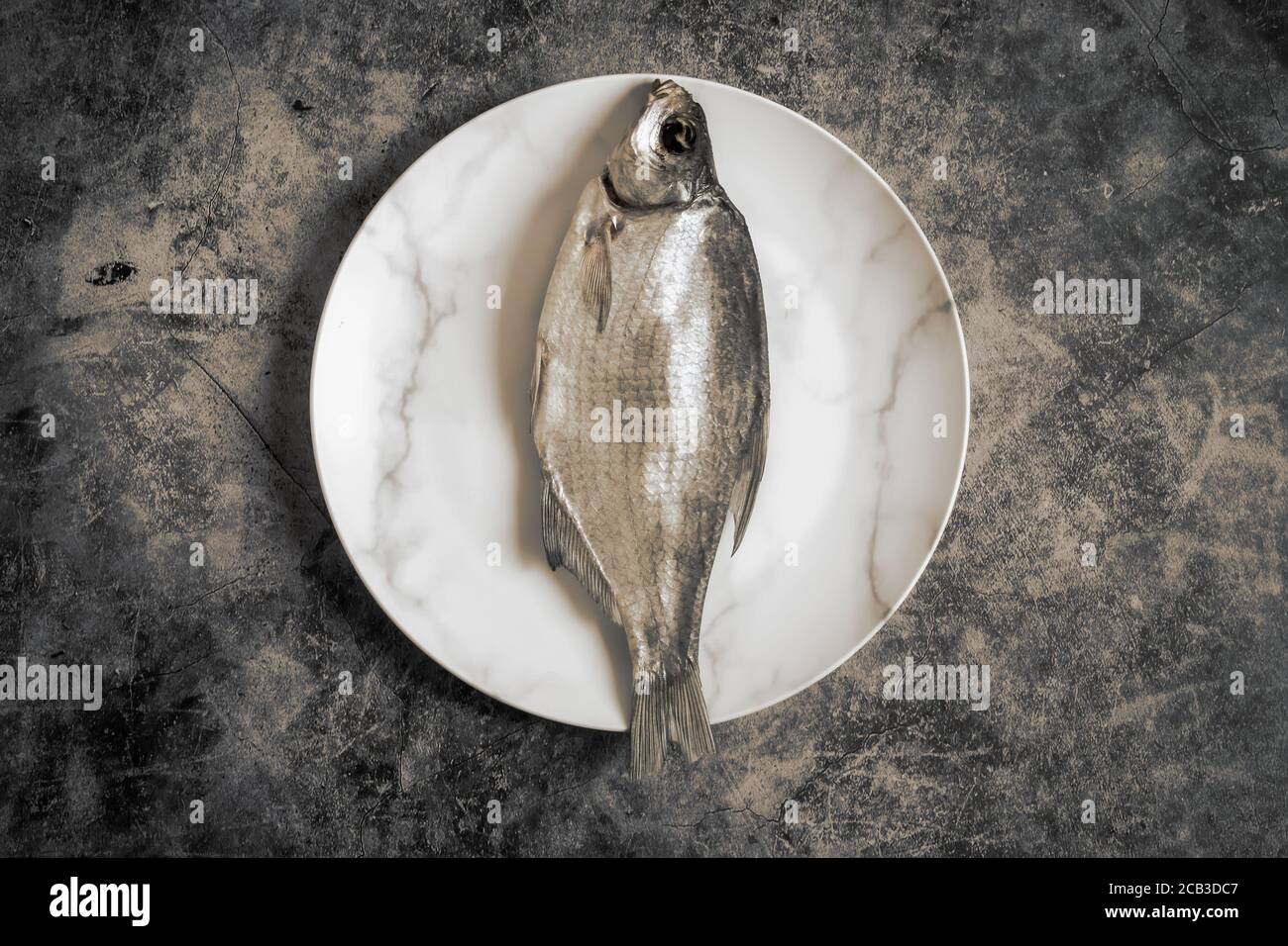 Salted and dried fish on a plate Stock Photo