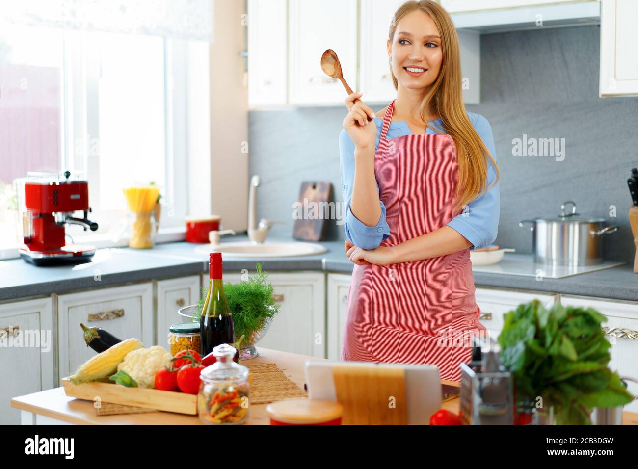 Young 30s woman in apron hi-res stock photography and images - Alamy