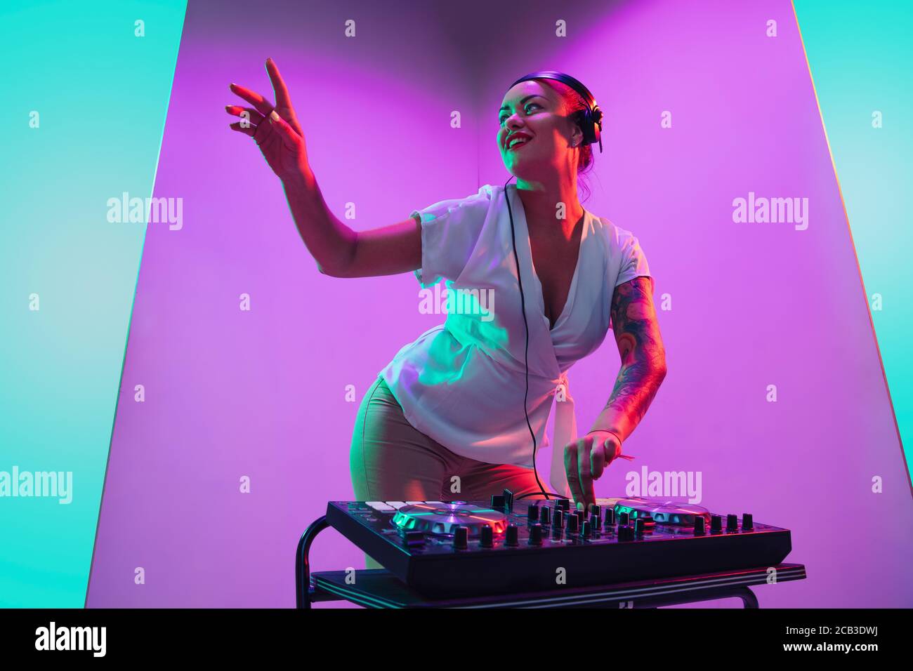 Drive. Young female musician in headphones performing on purple