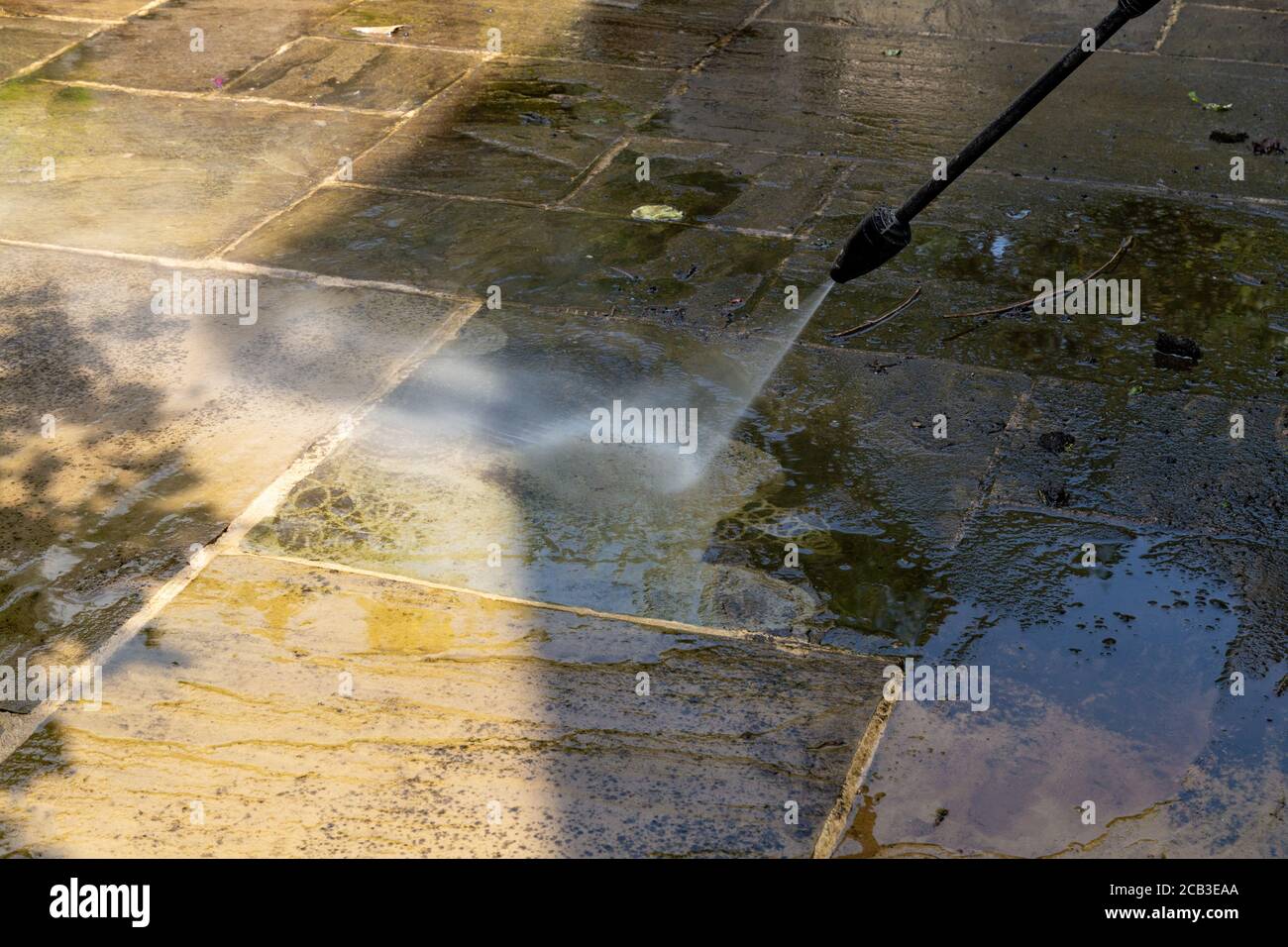 Patio Cleaning. Pressure washing an Indian slate patio Stock Photo Alamy