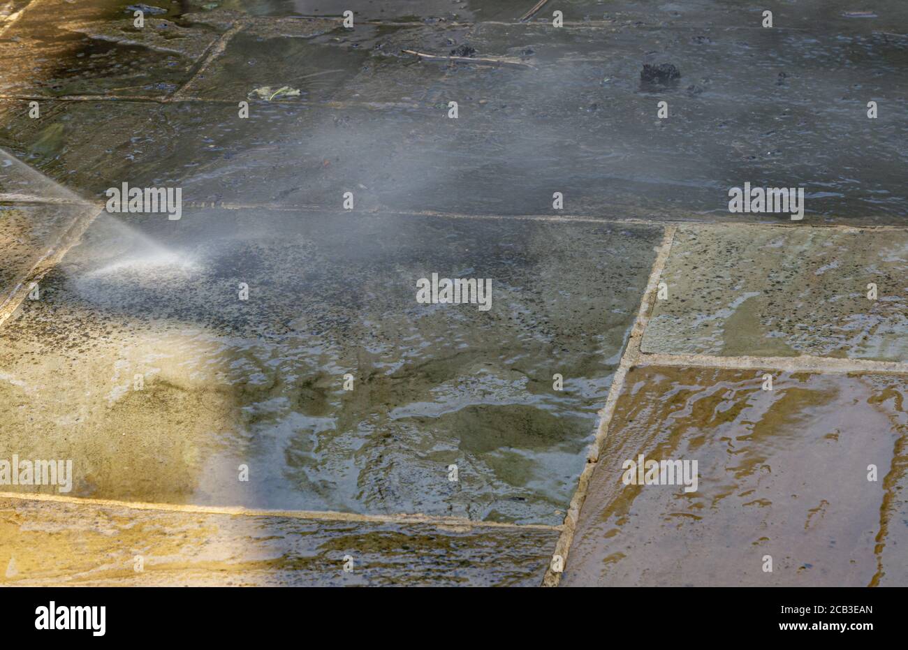 Patio Cleaning. Pressure washing an Indian slate patio Stock Photo Alamy
