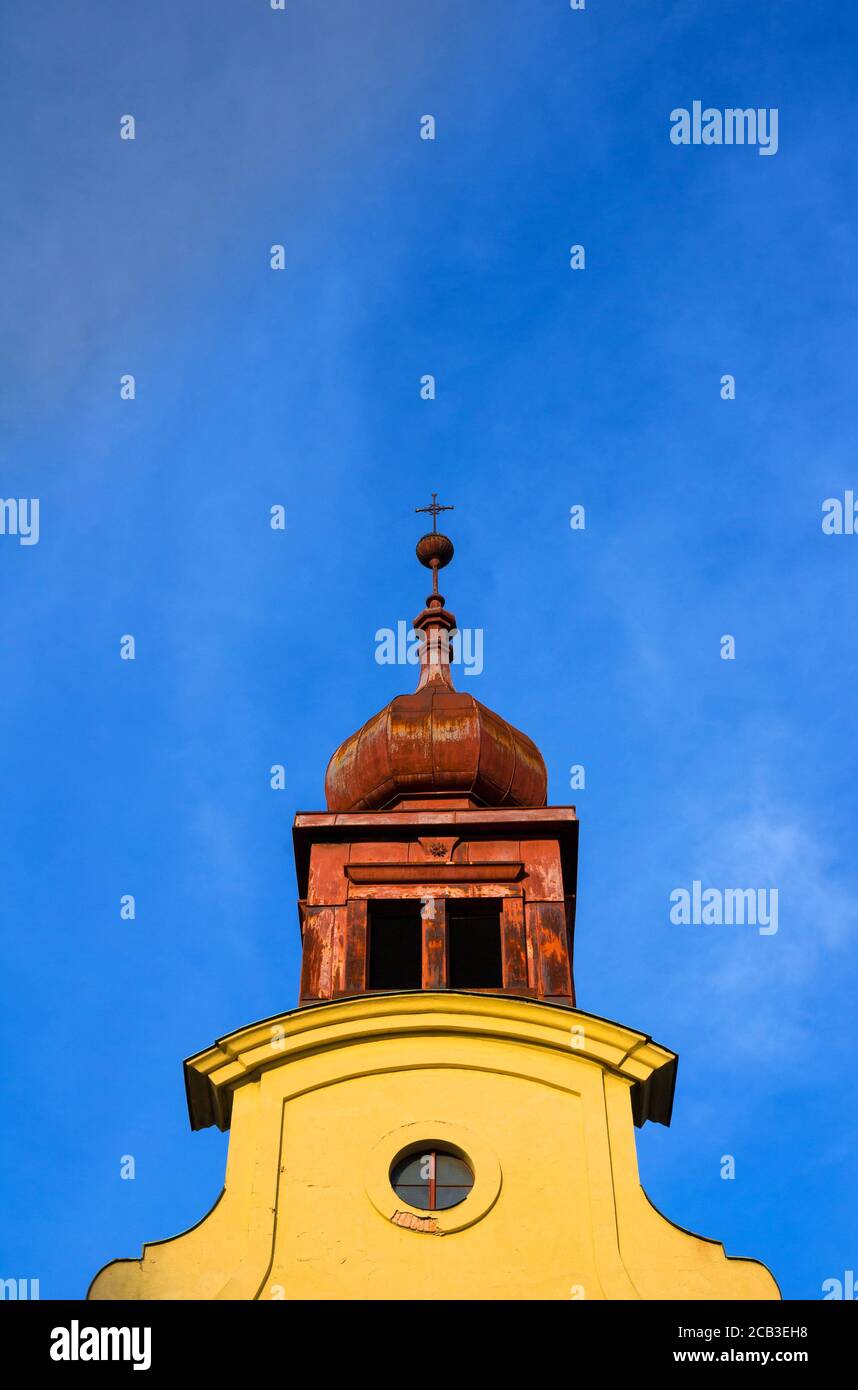 Church of Saint John Baptist, Opava, Silesia, Czech Republic / Czechia - detail of bell tower with cross on the top. Sacral building is made in baroqu Stock Photo