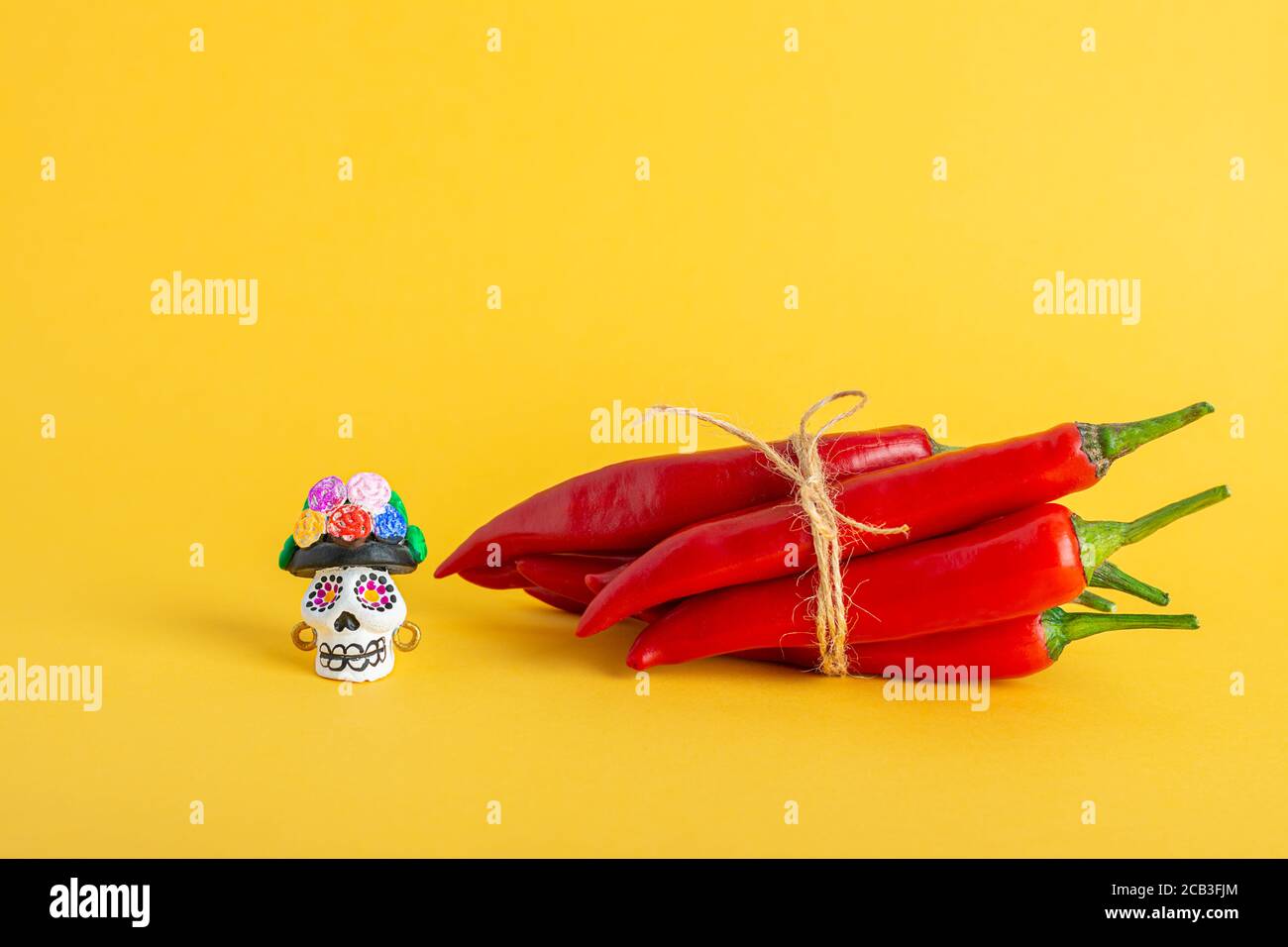 Red hot chili pepper and Catrina La Calavera Garbancera , Dapper Skeleton, Elegant Skull Stock Photo