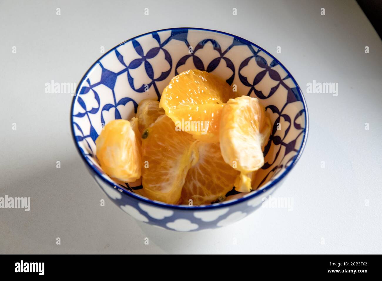 Mandarin, natjie or satsuma in color peeled in a lovely designed bowl and ready to be served. A clean background with texture Stock Photo