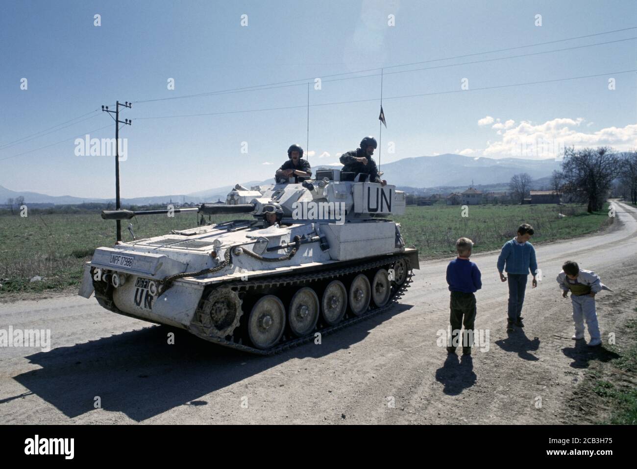 30th March 1994 During the war in Bosnia: local children are attracted by a British Army FV107 Scimitar of the Light Dragoons Regiment, parked just east of the British base in Bila, near Vitez. Stock Photo